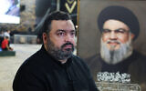 Jawad Nasrallah, son of late Hezbollah leader Hassan Nasrallah, sits at the burial site ahead of the first anniversary of his father's assassination, on the outskirts of Beirut, Lebanon, September 24, 2025. (Reuters/Mohamed Azakir)