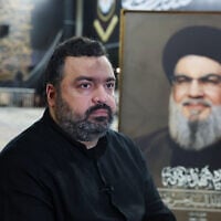 Jawad Nasrallah, son of late Hezbollah leader Hassan Nasrallah, sits at the burial site ahead of the first anniversary of his father's assassination, on the outskirts of Beirut, Lebanon, September 24, 2025. (Reuters/Mohamed Azakir)