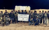 Contractors for the Gaza Humanitarian Foundation pose with a banner reading "Make Gaza Great Again." (Facebook, used in accordance with Clause 27a of the Copyright Law)
