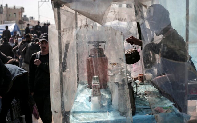 A man makes tea at a camp for displaced Palestinians in Rafah, on the southern Gaza Strip on February 28, 2024, amid ongoing battles between Israel and terror group Hamas. (AFP) A man makes tea at a camp for displaced Palestinians in Rafah, on the southern Gaza Strip on February 28, 2024, amid ongoing battles between Israel and terror group Hamas. (AFP)