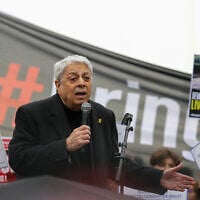 French singer and songwriter Enrico Macias addresses the audience during a gathering organized by the Representative Council of Jewish Institutions of France (CRIF) calling for the release of the hostages held in Gaza since the Hamas-led October 7 attacks on Israel, at the Trocadeo esplanade in Paris, on April 7, 2024 (Thomas SAMSON / AFP)