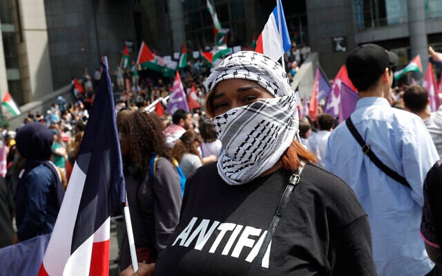 A protester wears a keffiyeh and an 'Antifa' t-shirt during a rally against Islamophobia, in Paris on May 11, 2025. (GEOFFROY VAN DER HASSELT / AFP) A protester wears a keffiyeh and an 'Antifa' t-shirt during a rally against Islamophobia, in Paris on May 11, 2025. (GEOFFROY VAN DER HASSELT / AFP)