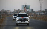 International Red Cross (ICRC) vehicles drive in Deir el-Balah as they transport US-Israeli hostage Edan Alexander on May 12, 2025, after he was handed over by Hamas. (Eyad Baba / AFP)