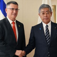 Foreign Minister Gideon Sa'ar (L) shakes hands with his Japanese counterpart Takeshi Iwaya at the Foreign Ministry in Tokyo on May 13, 2025. (Photo by Kazuhiro NOGI / AFP)