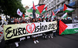 FILE: Anti-Israel protesters and BDS activists hold Palestinian flags and a banner reading 'Country of apartheid ... Israel,' during a demonstration prior to the grand final of the Eurovision Song Contest 2025 in Basel, Switzerland, May 17, 2025. (SEBASTIEN BOZON / AFP)