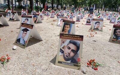 Portraits of slain Iranians are displayed in an area of Esplanades des Invalides in Paris on July 8, 2025, as part of a campaign by French human rights activists to stop executions in the Islamic Republic. (Delphine TOUITOU / AFP)