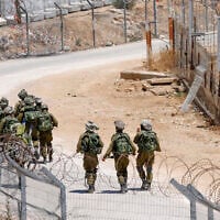 Israeli troops patrol the border fence with Syria near the Druze village of Majdal Shams in the Golan Heights on July 23, 2025 (Jalaa MAREY / AFP)