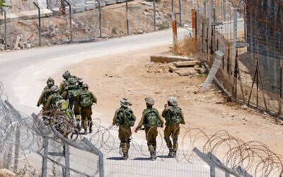 Israeli troops patrol the border fence with Syria near the Druze village of Majdal Shams in the Golan Heights on July 23, 2025 (Jalaa MAREY / AFP)