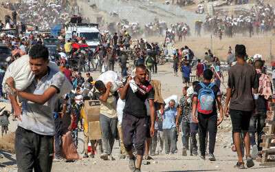 People walk with bags of humanitarian aid they received at a distribution center run by the US- and Israel-backed Gaza Humanitarian Foundation (GHF), as they cross the Netzarim corridor in the central Gaza Strip, on August 22, 2025. (Eyad BABA / AFP) People walk with bags of humanitarian aid they received at a distribution center run by the US- and Israel-backed Gaza Humanitarian Foundation (GHF), as they cross the Netzarim corridor in the central Gaza Strip, on August 22, 2025. (Eyad BABA / AFP)