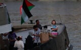 Swedish climate activist Greta Thunberg (R) is seen on board of a vessel of a civilian flotilla, carrying pro-Palestinian and anti-Israel activists, and humanitarian aid and aiming to break the blockade of the Gaza Strip, moored at Barcelona port on September 1, 2025 (Lluis GENE / AFP)