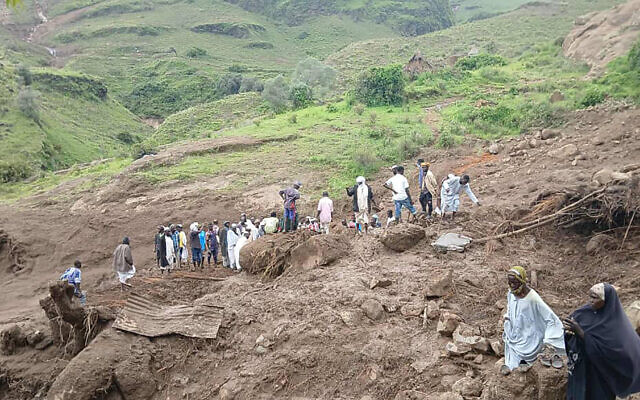 This handout image made available by the Sudan Liberation Movement/Army (SLM), on September 2, 2025, shows people inspecting the debris after a landslide devastated the village of Tarasin in Sudan's Jebel Marra area (SUDAN LIBERATION MOVEMENT/ARMY / AFP) This handout image made available by the Sudan Liberation Movement/Army (SLM), on September 2, 2025, shows people inspecting the debris after a landslide devastated the village of Tarasin in Sudan's Jebel Marra area (SUDAN LIBERATION MOVEMENT/ARMY / AFP)