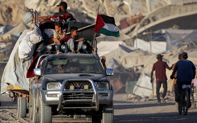 A Palestinian flag flies from a truck carrying people and children with their belongings as people evacuate southbound from Gaza City on September 2, 2025. (Eyad BABA / AFP) A Palestinian flag flies from a truck carrying people and children with their belongings as people evacuate southbound from Gaza City on September 2, 2025. (Eyad BABA / AFP)