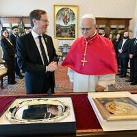 This handout photo taken on September 4, 2025, and released by the Vatican Media shows Pope Leo XIV (right) and President Isaac Herzog exchanging gifts during a private audience in the Vatican. (Photo by Handout / VATICAN MEDIA / AFP)