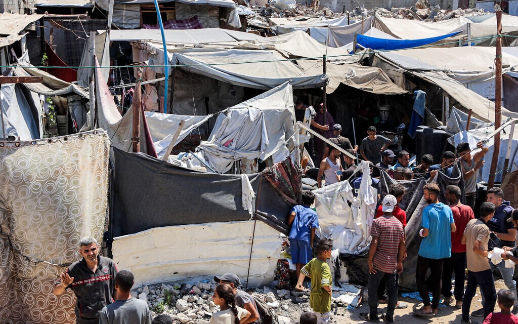 People inspect damages at a tent encampment that was sheltering displaced people, after it was hit by an Israeli strike, near Shifa Hospital in Gaza City on September 4, 2025 (Omar AL-QATTAA / AFP)