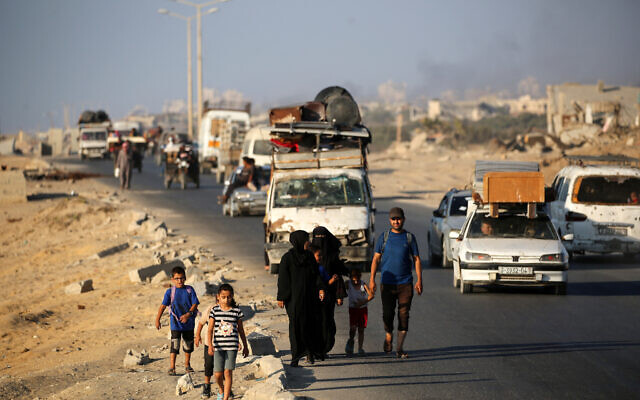 Palestinians fleeing south, ride vehicles with their belongings, along the coastal road near the Nuseirat refugee camp in the central Gaza Strip, on August 5, 2025 (Eyad BABA / AFP)