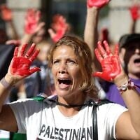 A protestor shows her red-tainted hands during a pro-Palestinian, anti-Israel demonstration in front of the Israeli Embassy in Madrid, on September 6, 2025. (Thomas COEX / AFP)