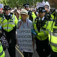 An elderly protester is taken away by police officers at a "Lift The Ban" demonstration in support of the proscribed group Palestine Action, calling for the recently imposed terrorism ban to be lifted, in Parliament Square, central London, on September 6, 2025. (Photo by JUSTIN TALLIS / AFP)