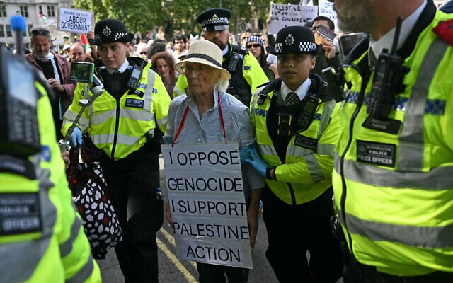 An elderly protester is taken away by police officers at a "Lift The Ban" demonstration in support of the proscribed group Palestine Action, calling for the recently imposed terrorism ban to be lifted, in Parliament Square, central London, on September 6, 2025. (Photo by JUSTIN TALLIS / AFP)