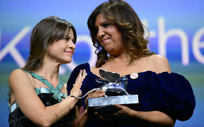Director Kaouther Ben Hania receives the Silver Lion - Grand Jury Prize for "The Voice of Hind Rajab" from Italian film director Maura Delpero during the award ceremony of the 82nd Venice Film Festival on September 6, 2025 at Venice Lido. (Tiziana FABI / AFP)