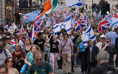Protesters hold placards and wave flags during a 'march against antisemitism' demonstration in central London, on September 7, 2025, (Photo by CARLOS JASSO / AFP)