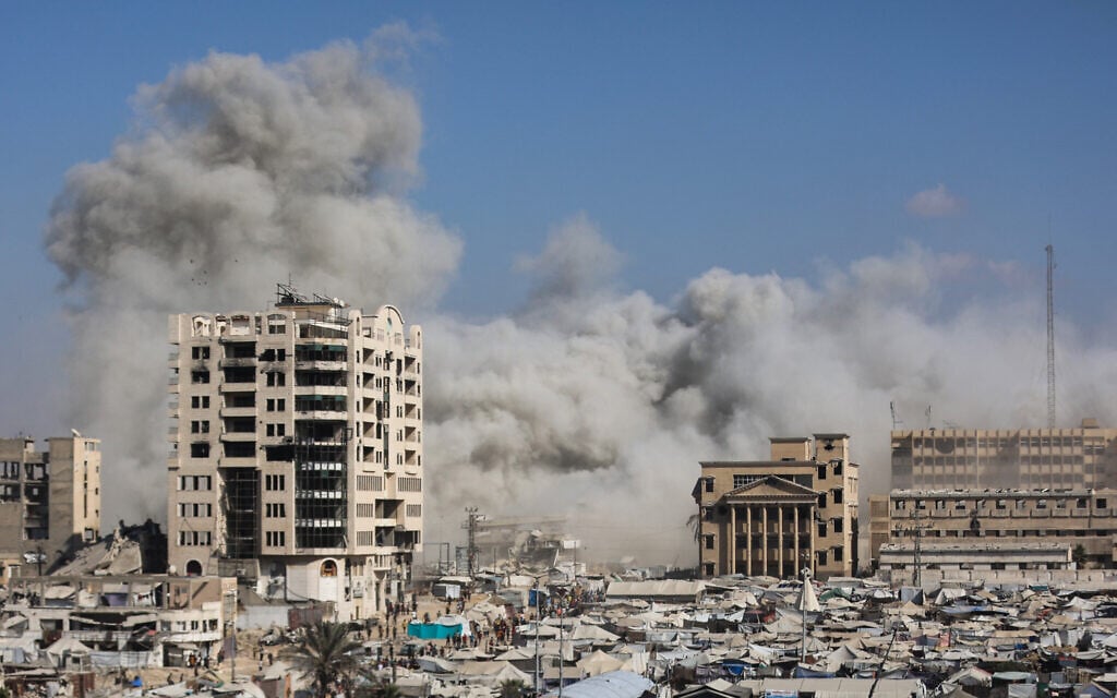 Smoke billows near tents sheltering displaced Palestinians after an Israeli strike destroyed a building called al-Ruya Tower, in Gaza City's Rimal area, on September 8, 2025. (Omar AL-QATTAA / AFP) Smoke billows near tents sheltering displaced Palestinians after an Israeli strike destroyed a building called al-Ruya Tower, in Gaza City's Rimal area, on September 8, 2025. (Omar AL-QATTAA / AFP)