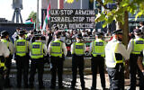 Police stand on duty as demonstrators protest outside the entrance to the Defence and Security Equipment International (DSEI) fair at the ExCeL center, in east London, on September 9, 2025. (Toby Shepheard/AFP)
