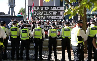 Police stand on duty as demonstrators protest outside the entrance to the Defence and Security Equipment International (DSEI) fair at the ExCeL center, in east London, on September 9, 2025. (Toby Shepheard/AFP)