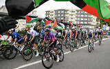 Pro-Palestinian, anti-Israel protesters wave flags and shout as the peloton rides by in Poio at the start of the 16th stage of the Vuelta a Espana on September 9, 2025. (Miguel Riopa/AFP)