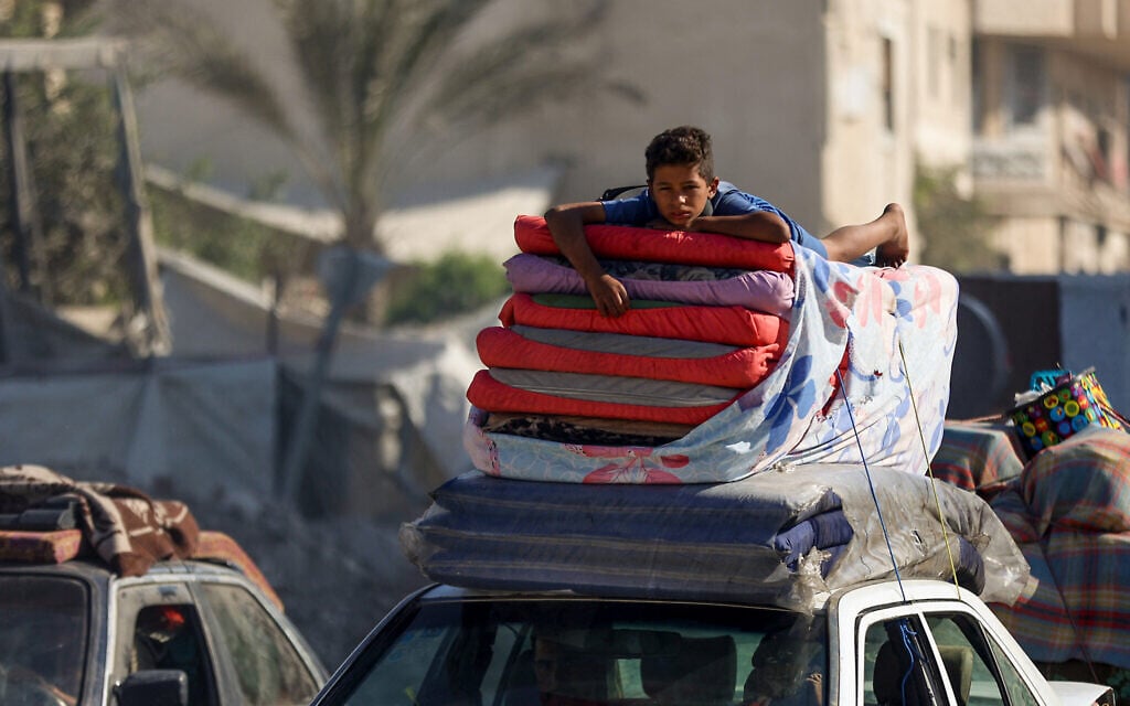 A boy lies on a pile of mattresses as Palestinians transport their belongings while evacuating Gaza City towards south Gaza, on September 10, 2025.(Omar AL-QATTAA / AFP)