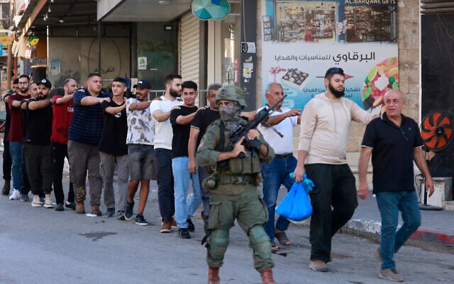 Israeli soldiers detain Palestinians during a raid following an attack on an Israeli military vehicle near the Nitzanei Oz Crossing west of Tulkarem in the West Bank on September 11, 2025. (Jaafar ASHTIYEH / AFP)