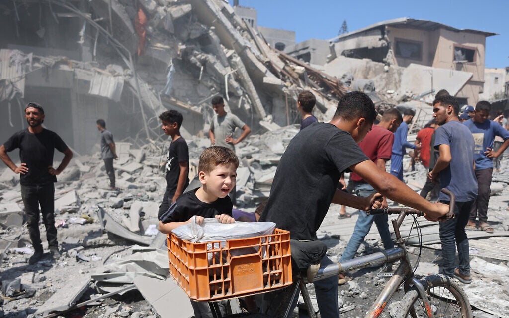 Palestinians walk past a destroyed building after an Israeli strike on Al-Nassr Street in Gaza City on September 12, 2025. (Omar AL-QATTAA / AFP) Palestinians walk past a destroyed building after an Israeli strike on Al-Nassr Street in Gaza City on September 12, 2025. (Omar AL-QATTAA / AFP)