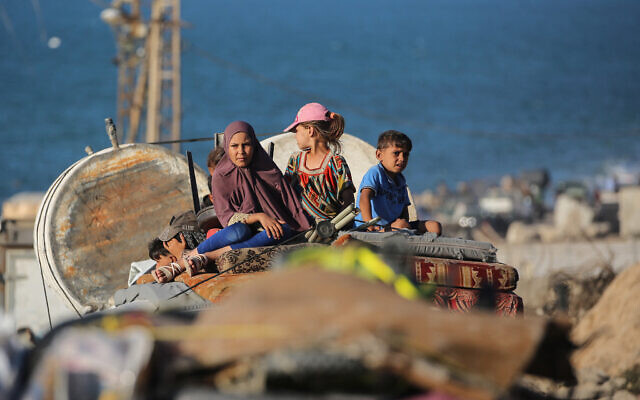 Children sit atop piled up mattresses as Palestinians flee south from Gaza City with their belongings, via on the coastal road near the Nuseirat refugee camp in the central Gaza Strip, on September 12, 2025. (Eyad BABA / AFP)