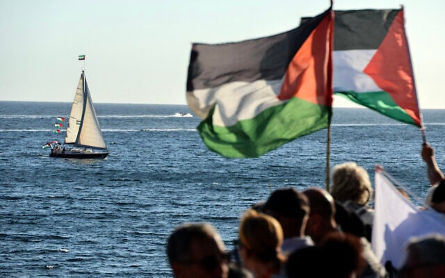 Activists wave Palestinian flags as they gather to support a flotilla carrying humanitarian aid and pro-Palestinian, anti-Israel activists in Ajaccio, on the French Mediterranean island of Corsica, on September 12, 2025 (Pascal POCHARD-CASABIANCA / AFP)
