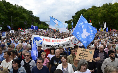 Demonstrators take part in an anti-Israel, pro-Palestinian rally titled "Stop the genocide in Gaza! No weapons in war zones! Peace instead of arms race!" on September 13, 2025, at the Brandenburg Gate in Berlin. (John MACDOUGALL / AFP)