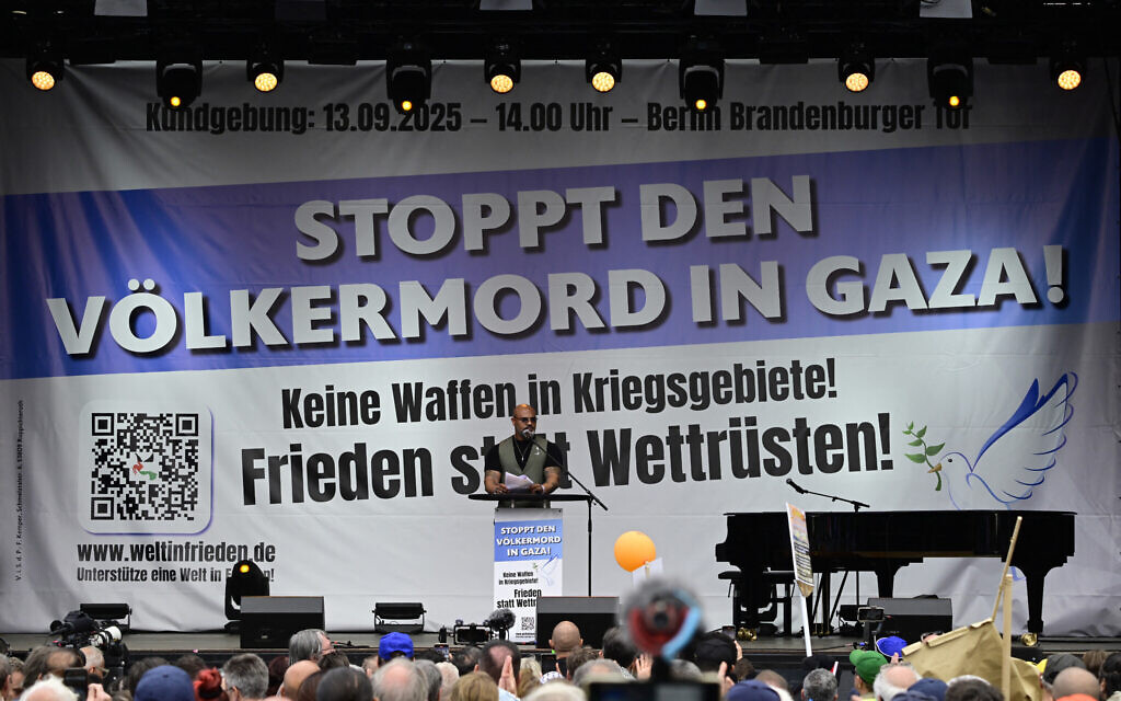 German rapper Massiv aka Wasim Taha speaks on a stage during a pro-Palestinian, anti-Israel rally titled "Stop the genocide in Gaza! No weapons in war zones! Peace instead of arms race!" on September 13, 2025, at the Brandenburg Gate in Berlin. (John MacDougall / AFP)