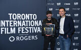 Director Barry Avrich, winner of the People's Choice Documentary Award for 'The Road Between Us: The Ultimate Rescue,' poses with producer Mark Selby (R) at the 2025 Toronto International Film Festival awards ceremony, in Toronto, Ontario, on September 14, 2025. (Harold Feng / Getty Images via AFP)