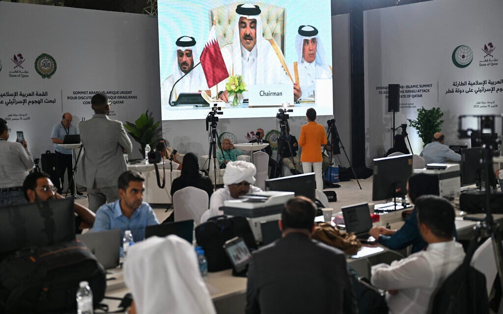 Reporters follow Qatar's Emir Sheikh Tamim bin Hamad Al-Thani's address at the media center during the opening of the 2025 Arab Islamic emergency summit in Doha on September 15, 2025. (MAHMUD HAMS / AFP)