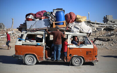 Displaced Palestinians move with their belongings southwards on a road in the Nuseirat refugee camp area in the central Gaza Strip following renewed Israeli evacuation orders for Gaza City on September 16, 2025. (Eyad BABA / AFP)