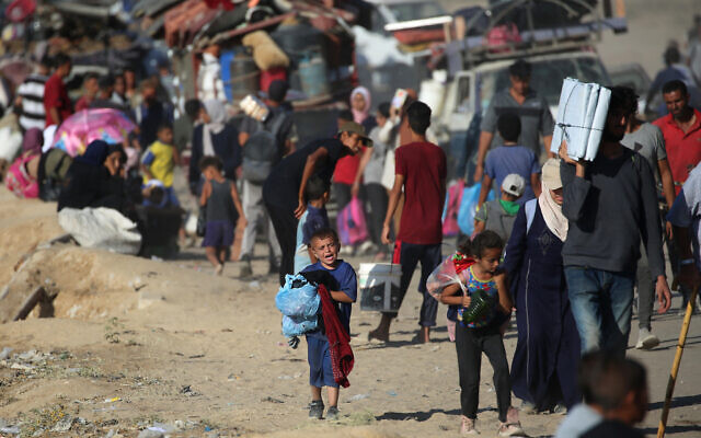 Displaced Palestinians move with their belongings southwards on a road in the Nuseirat refugee camp area in the central Gaza Strip following renewed Israeli evacuation orders for Gaza City on September 16, 2025. (Eyad BABA / AFP)