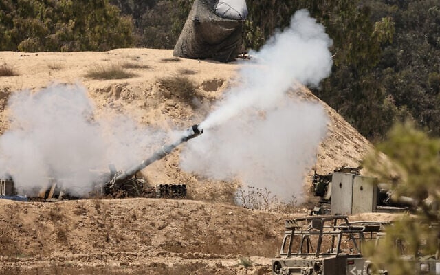 This picture taken from a position at Israel's border with the Gaza Strip shows a burst of smoke as an Israeli army self-propelled artillery Howitzer fires a round from southern Israel toward the Gaza Strip, on September 17, 2025. (Photo by Jack GUEZ / AFP)