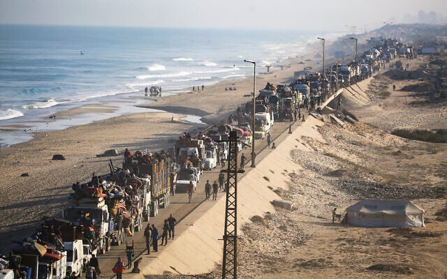 Displaced Palestinians move with their belongings southward on a road in the Nuseirat area in the central Gaza Strip following renewed Israeli evacuation orders for Gaza City, September 18, 2025. (Photo by Eyad BABA / AFP)