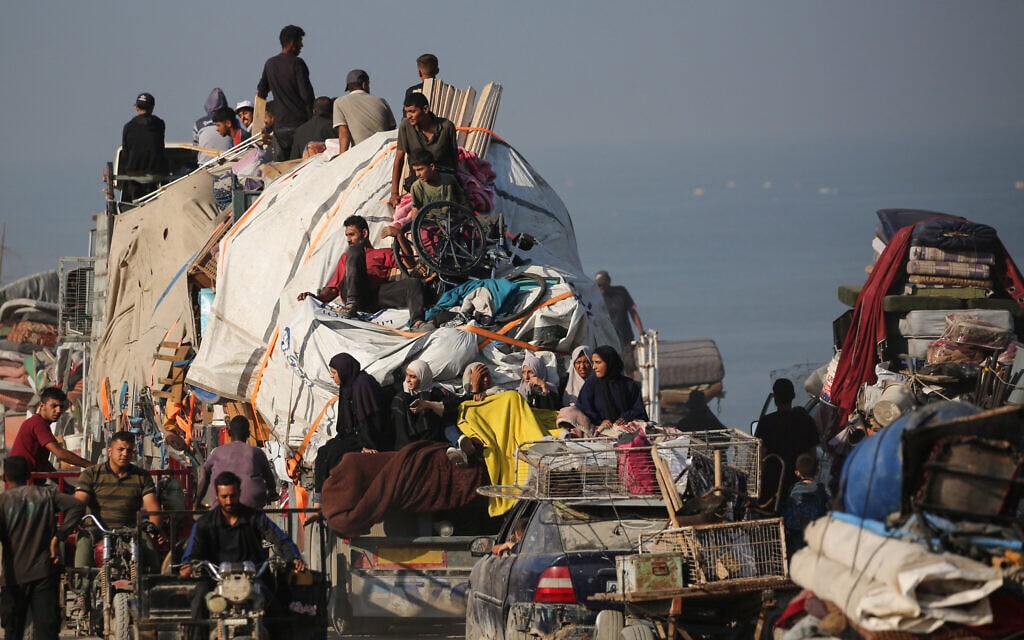Displaced Palestinians move with their belongings southwards on a road in the Nuseirat refugee camp area in the central Gaza Strip on September 18, 2025. (Eyad BABA / AFP)