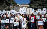 Employees of United Nations agencies hold placards in front of the UN Offices Geneva, on September 18, 2025, to honor the memory of the 370 UN employees killed in Gaza, calling for the end to the Israel-Hamas war. (Elodie Le Maou/AFP)