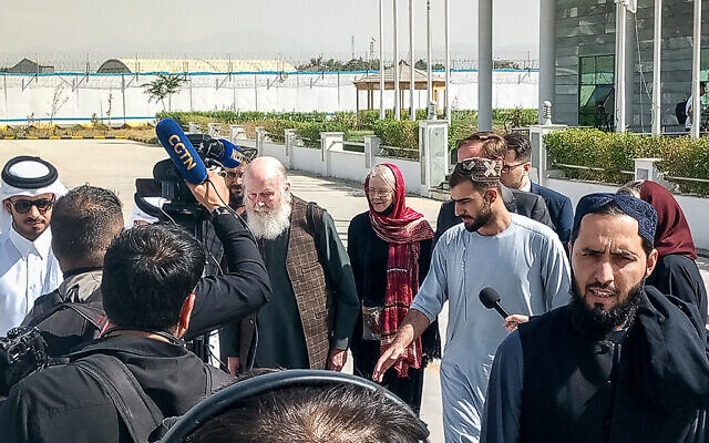 British nationals Peter Reynolds (centre L) and his wife Barbara (centre R) speak with journalists upon their release from Taliban custody at Kabul airport on September 19, 2025. (AFP)
