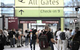 Passengers walk at Terminal 1 of Berlin Brandenburg BER Airport Willy-Brandt in Schoenefeld, southeast of Berlin, on September 20, 2025, after major European airports were hit by "cyber-related disruption" affecting automated check-in and baggage drop systems and causing delays. (Photo by Tobias SCHWARZ / AFP)