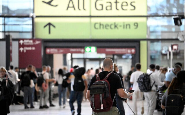 Passengers walk at Terminal 1 of Berlin Brandenburg BER Airport Willy-Brandt in Schoenefeld, southeast of Berlin, on September 20, 2025, after major European airports were hit by "cyber-related disruption" affecting automated check-in and baggage drop systems and causing delays. (Photo by Tobias SCHWARZ / AFP) Passengers walk at Terminal 1 of Berlin Brandenburg BER Airport Willy-Brandt in Schoenefeld, southeast of Berlin, on September 20, 2025, after major European airports were hit by "cyber-related disruption" affecting automated check-in and baggage drop systems and causing delays. (Photo by Tobias SCHWARZ / AFP)