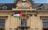 The Palestinian state flag flies at the entrance of the City Hall in Saint-Ouen, in the northern suburbs of Paris on September 22, 2025. (BERTRAND GUAY / AFP)