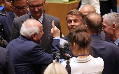Palestinian Ambassador to the UN Riyad Mansour (L) greets French President Emmanuel Macron (C) as he arrives for a United Nations Summit on Palestinians at UN headquarters during the United Nations General Assembly (UNGA) in New York on September 22, 2025.  (Photo by Ludovic MARIN / AFP)
