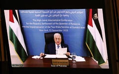 Palestinian Authority President Mahmud Abbas is displayed on a screen as he speaks remotely during a United Nations Summit on Palestinians at UN headquarters during the United Nations General Assembly (UNGA) in New York on September 22, 2025. (Ludovic MARIN / AFP)