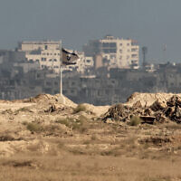 An Israeli flag flutters near destroyed buildings inside the Gaza Strip as pictured from the Israeli border, on September 25, 2025. (Jack GUEZ / AFP)